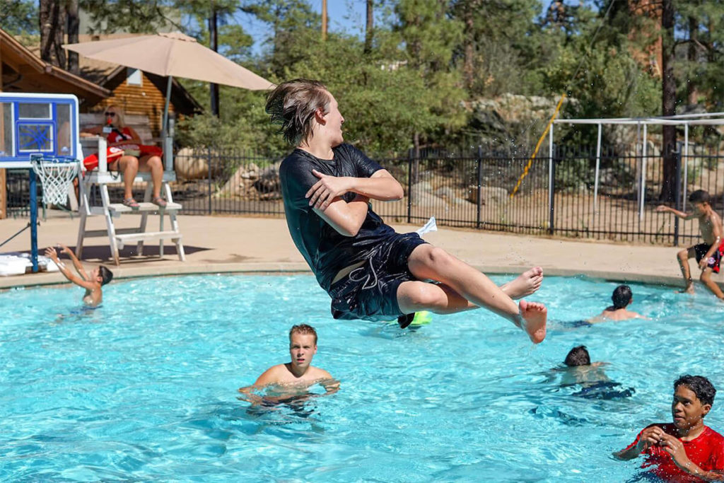 Boy jumping into the pool UCYC
